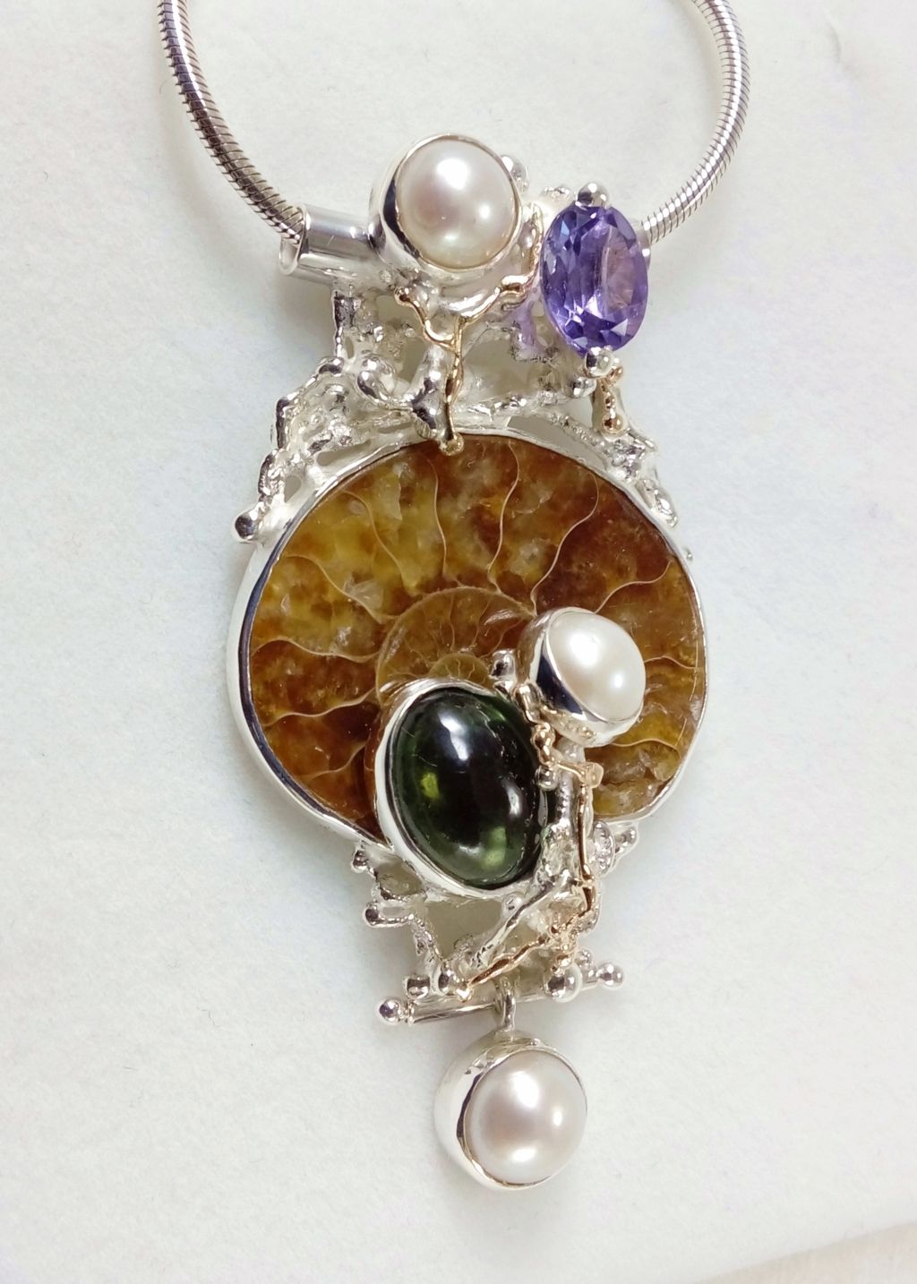 gregory pyra piro pendant 4921, art nouveau inspired fashion jewelry, jewellery with natural pearls and semi precious stones, contemporary jewelry from silver and gold, art jewellery with colour stones, contemporary jewelry with pearls and color stones, jewellery made from silver and gold with natural pearls and natural gemstones, shopping for diamonds and designer jewellery, accessories with color stones and pearls, artisan handcrafted jewellery with natural gemstones and natural pearls, jewelry made first hand, pendant with a vintage design, sterling silver and 14 karat gold pendant, pendant with faceted amethyst and fluorite, pendant with amethyst and ammonite, pendant with ammonite and fluorite, one of a kind handcrafted ring, where to find auctions with fine art and designer jewellery, where to buy gregory pyra piro jewelry right now