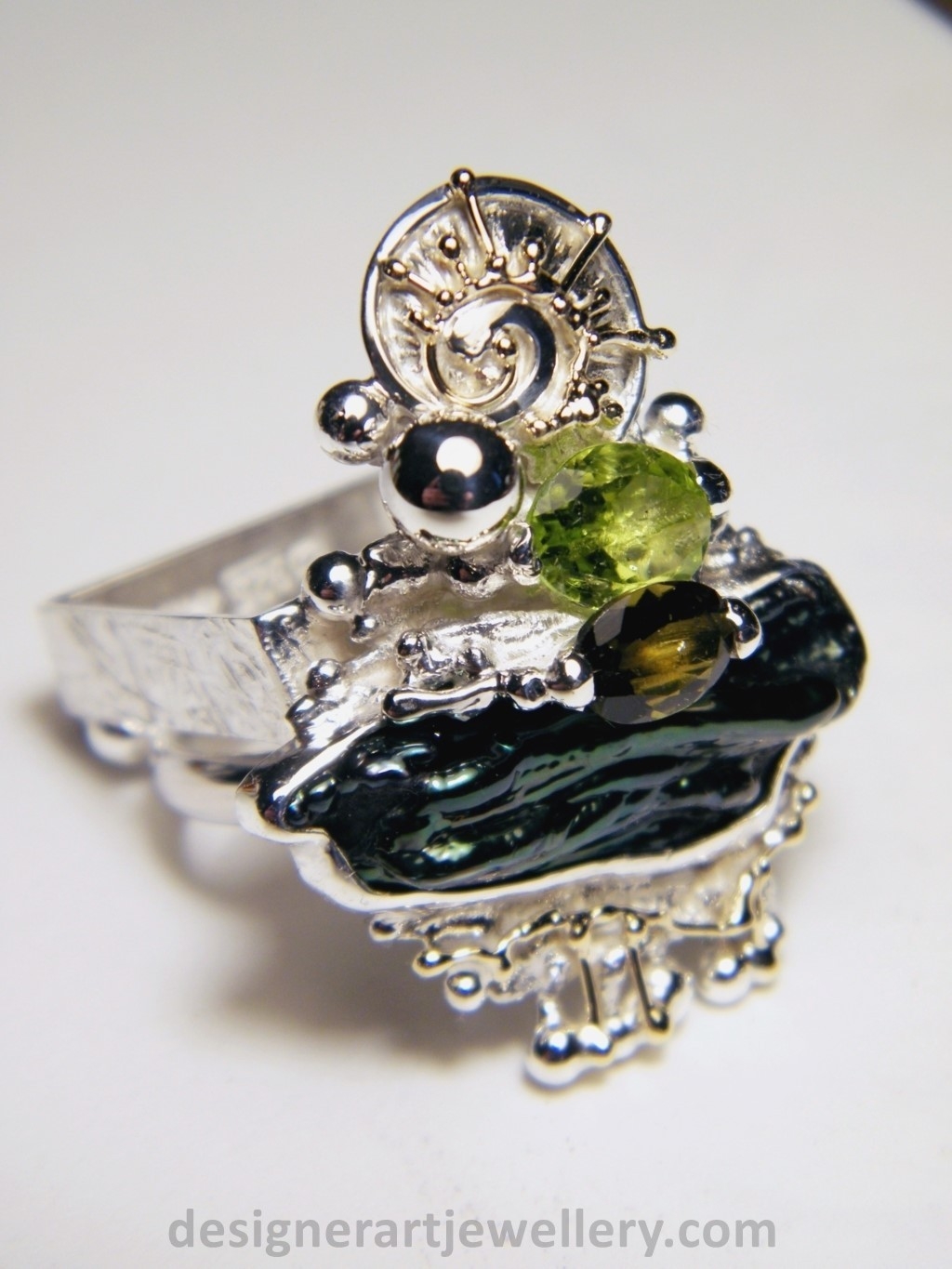wearable art jewelry to wear, meticulously handcrafted jewelry, sterling silver and 14k gold jewelry with semi precious stones, handmade jewelry with facet cut gemstones and cabochons, Art jewelry with pearl and peridot, art jewelry in sterling silver with peridot, art jewelry in 14 karat gold with green tourmaline, contemporary jewelry with green tourmaline and peridot, ring with green tourmaline and pearl, handcrafted ring with peridot and pearl, one of a kind rings handmade by artist, gregory pyra piro one of a kind square ring 1080, square ring with tourmaline and peridot, square ring with pearl and facet cut peridot, square ring with facet cut green tourmaline, one of a kind ring handmade by artist with green tourmaline and biwa pearl