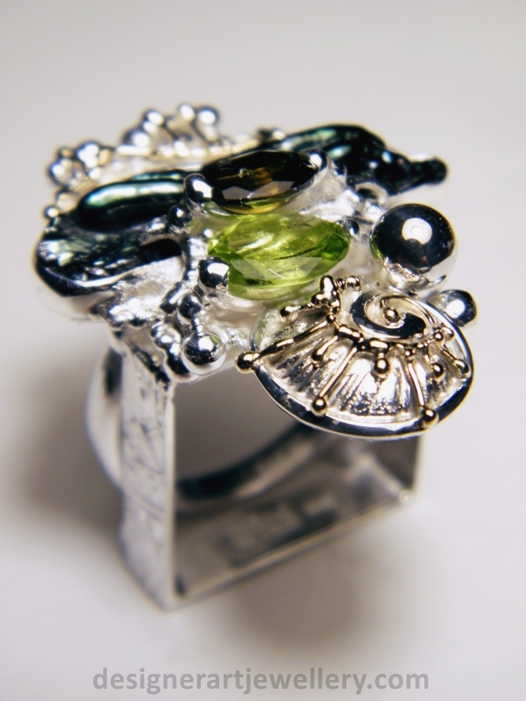 wearable art jewelry to wear, meticulously handcrafted jewelry, sterling silver and 14k gold jewelry with semi precious stones, handmade jewelry with facet cut gemstones and cabochons, Art jewelry with pearl and peridot, art jewelry in sterling silver with peridot, art jewelry in 14 karat gold with green tourmaline, contemporary jewelry with green tourmaline and peridot, ring with green tourmaline and pearl, handcrafted ring with peridot and pearl, one of a kind rings handmade by artist, gregory pyra piro one of a kind square ring 1080, square ring with tourmaline and peridot, square ring with pearl and facet cut peridot, square ring with facet cut green tourmaline, one of a kind ring handmade by artist with green tourmaline and biwa pearl