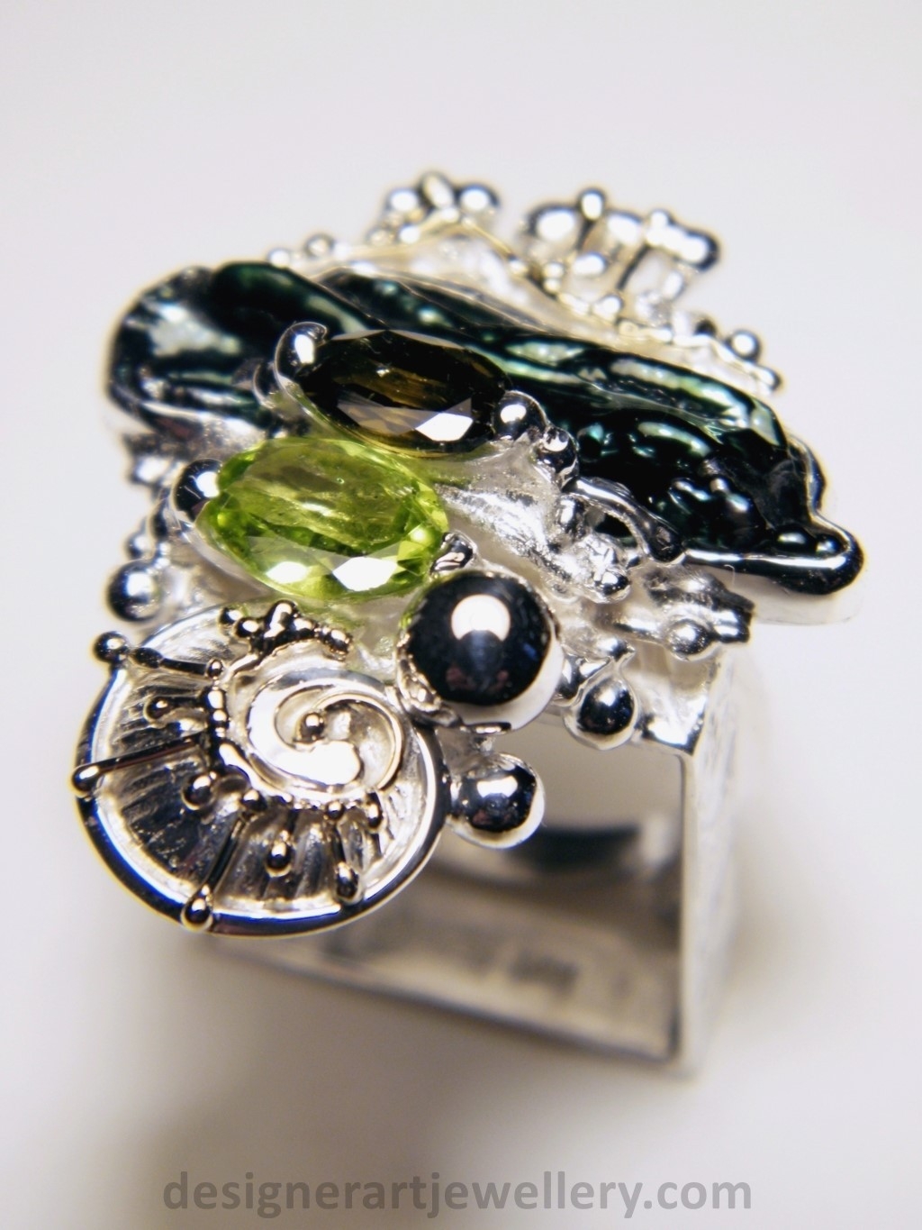 wearable art jewelry to wear, meticulously handcrafted jewelry, sterling silver and 14k gold jewelry with semi precious stones, handmade jewelry with facet cut gemstones and cabochons, Art jewelry with pearl and peridot, art jewelry in sterling silver with peridot, art jewelry in 14 karat gold with green tourmaline, contemporary jewelry with green tourmaline and peridot, ring with green tourmaline and pearl, handcrafted ring with peridot and pearl, one of a kind rings handmade by artist, gregory pyra piro one of a kind square ring 1080, square ring with tourmaline and peridot, square ring with pearl and facet cut peridot, square ring with facet cut green tourmaline, one of a kind ring handmade by artist with green tourmaline and biwa pearl
