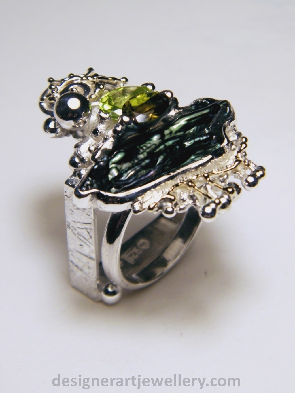 wearable art jewelry to wear, meticulously handcrafted jewelry, sterling silver and 14k gold jewelry with semi precious stones, handmade jewelry with facet cut gemstones and cabochons, Art jewelry with pearl and peridot, art jewelry in sterling silver with peridot, art jewelry in 14 karat gold with green tourmaline, contemporary jewelry with green tourmaline and peridot, ring with green tourmaline and pearl, handcrafted ring with peridot and pearl, one of a kind rings handmade by artist, gregory pyra piro one of a kind square ring 1080, square ring with tourmaline and peridot, square ring with pearl and facet cut peridot, square ring with facet cut green tourmaline, one of a kind ring handmade by artist with green tourmaline and biwa pearl