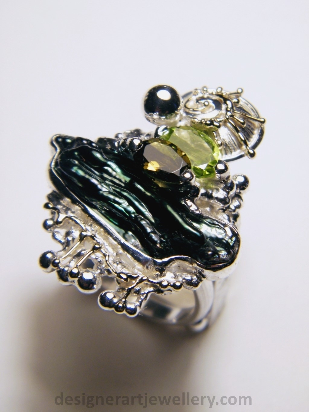 wearable art jewelry to wear, meticulously handcrafted jewelry, sterling silver and 14k gold jewelry with semi precious stones, handmade jewelry with facet cut gemstones and cabochons, Art jewelry with pearl and peridot, art jewelry in sterling silver with peridot, art jewelry in 14 karat gold with green tourmaline, contemporary jewelry with green tourmaline and peridot, ring with green tourmaline and pearl, handcrafted ring with peridot and pearl, one of a kind rings handmade by artist, gregory pyra piro one of a kind square ring 1080, square ring with tourmaline and peridot, square ring with pearl and facet cut peridot, square ring with facet cut green tourmaline, one of a kind ring handmade by artist with green tourmaline and biwa pearl