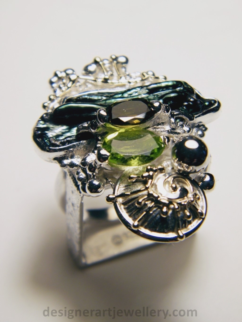 wearable art jewelry to wear, meticulously handcrafted jewelry, sterling silver and 14k gold jewelry with semi precious stones, handmade jewelry with facet cut gemstones and cabochons, Art jewelry with pearl and peridot, art jewelry in sterling silver with peridot, art jewelry in 14 karat gold with green tourmaline, contemporary jewelry with green tourmaline and peridot, ring with green tourmaline and pearl, handcrafted ring with peridot and pearl, one of a kind rings handmade by artist, gregory pyra piro one of a kind square ring 1080, square ring with tourmaline and peridot, square ring with pearl and facet cut peridot, square ring with facet cut green tourmaline, one of a kind ring handmade by artist with green tourmaline and biwa pearl